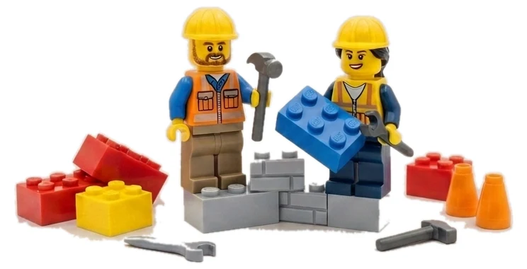 Two Lego builders assembling a brick wall